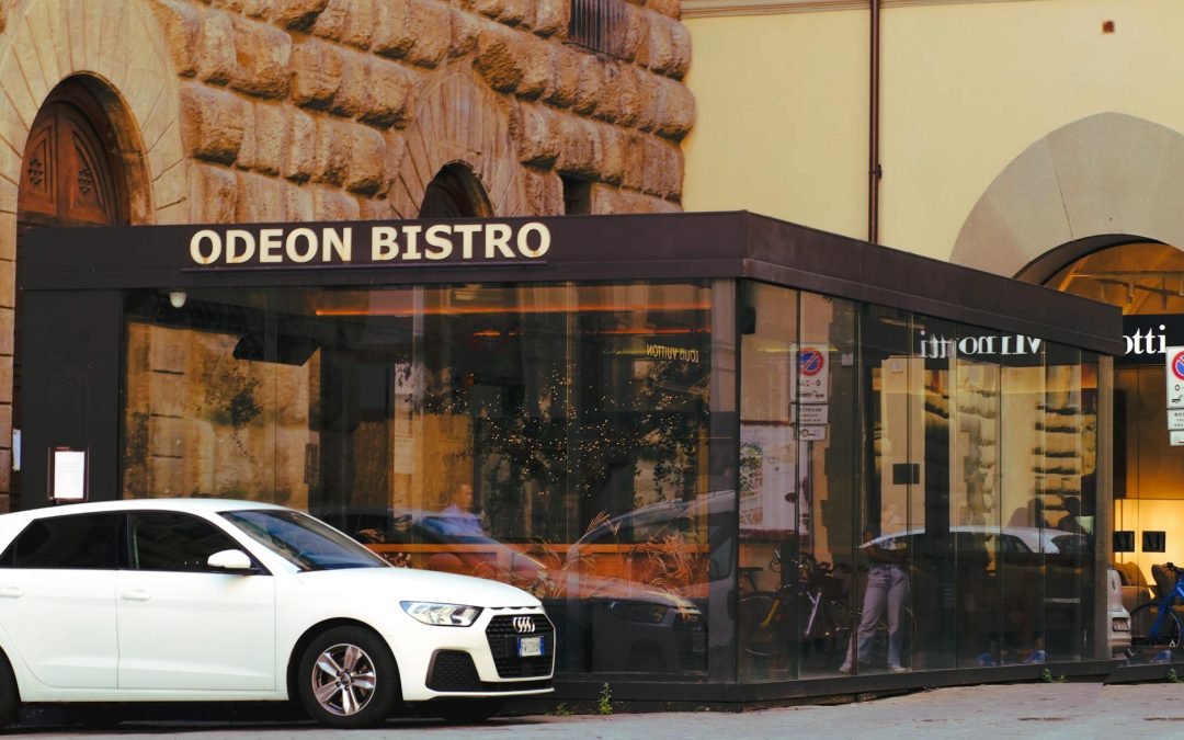A Car Parked next to the Odeon Bistro in Florence, Italy