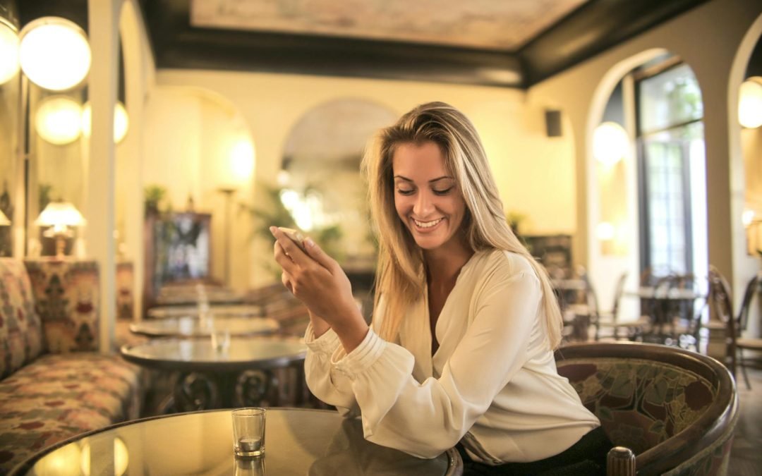 Cheerful female having drink in elegant bar