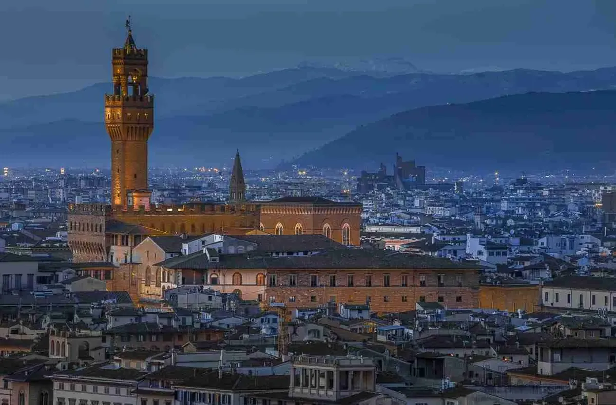 The tower of Palazzo Vecchio above the Florence skyline at dusk
